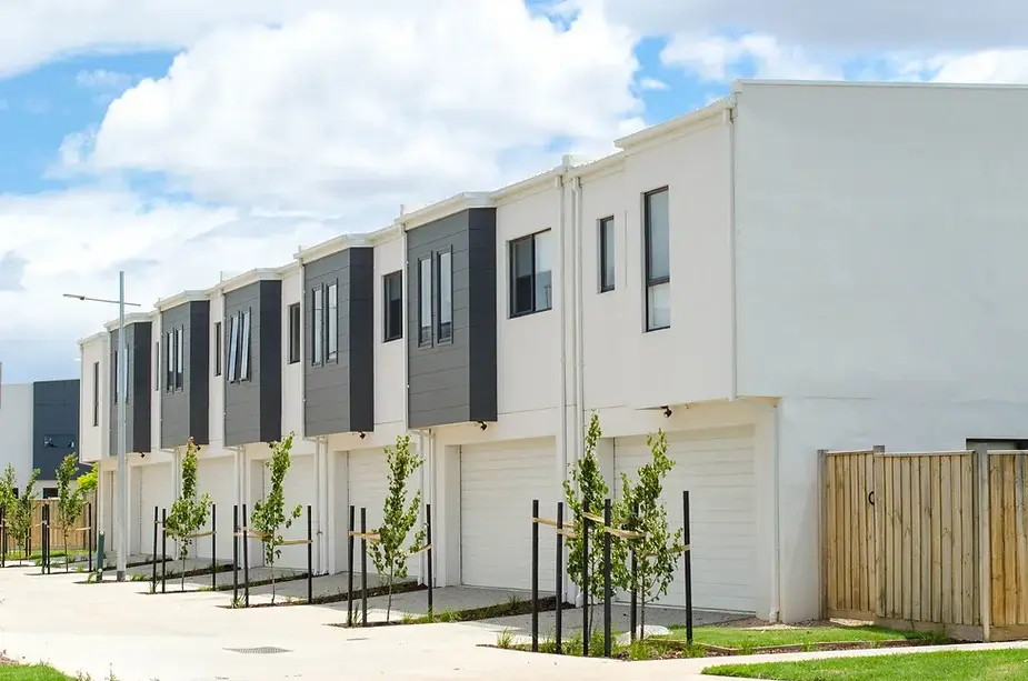 Modern row of newly built townhouses, illustrating the concept of investing in new properties in Australia.