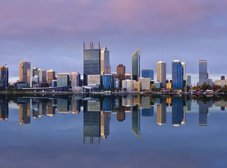 Perth city skyline reflected in water at dawn, showcasing Perth’s appeal as a promising property investment landscape.